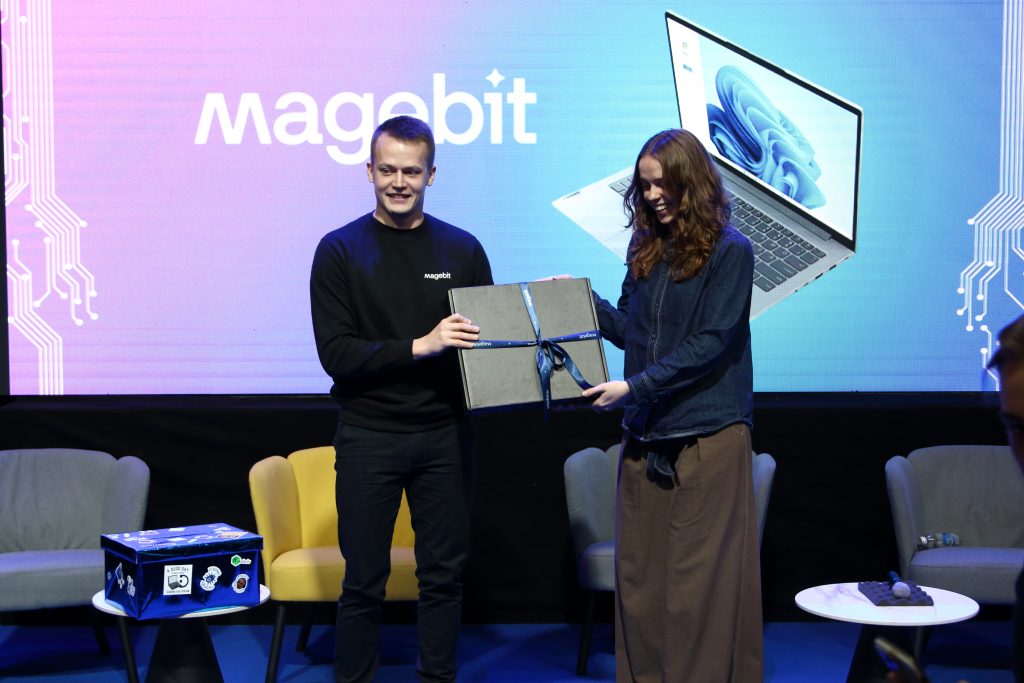 A laptop presented on stage at Datorium Tech Stage