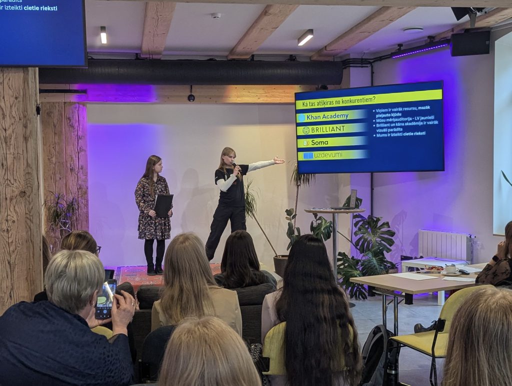 Participants filming a presentation at the PyGirls event